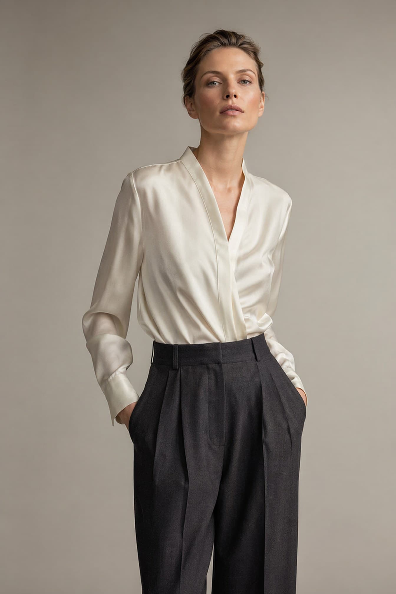 Blonde updo · charcoal trousers