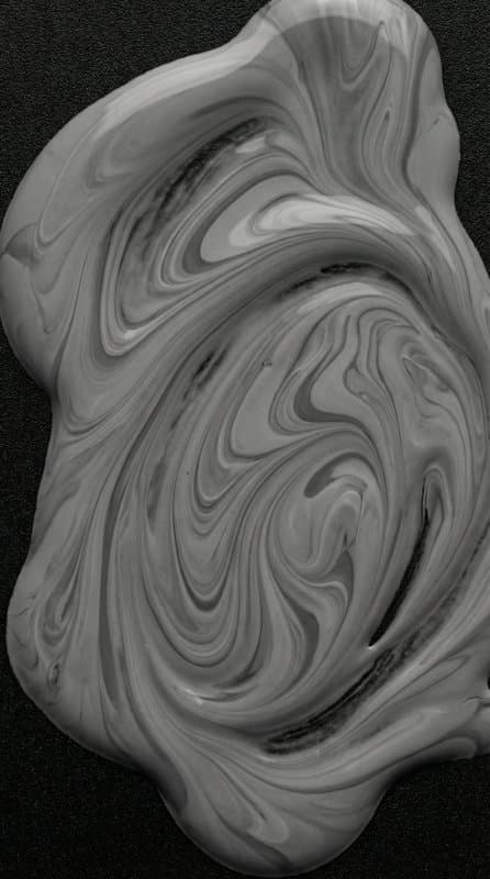 Marbled cream swirled into soft folds, shot close