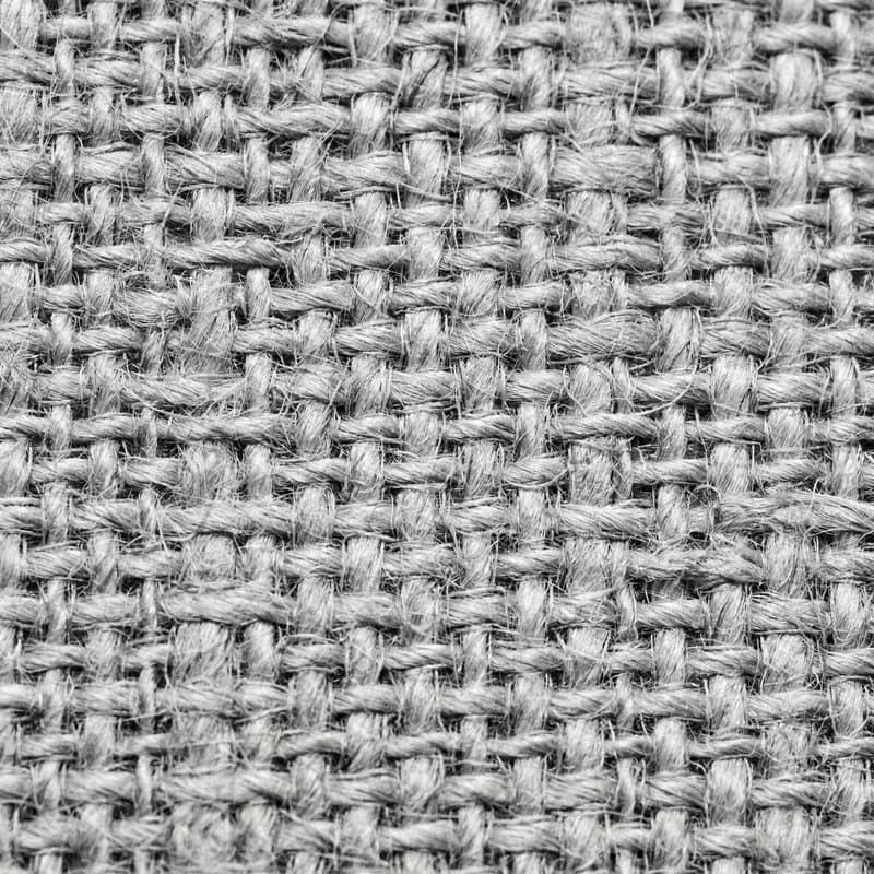 Macro of a loose basket weave in undyed yarn